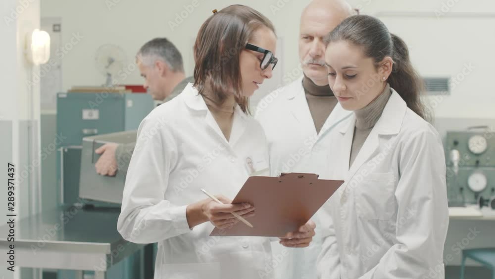 Scientific team discussing a project in the lab Scientific team discussing a project in the lab