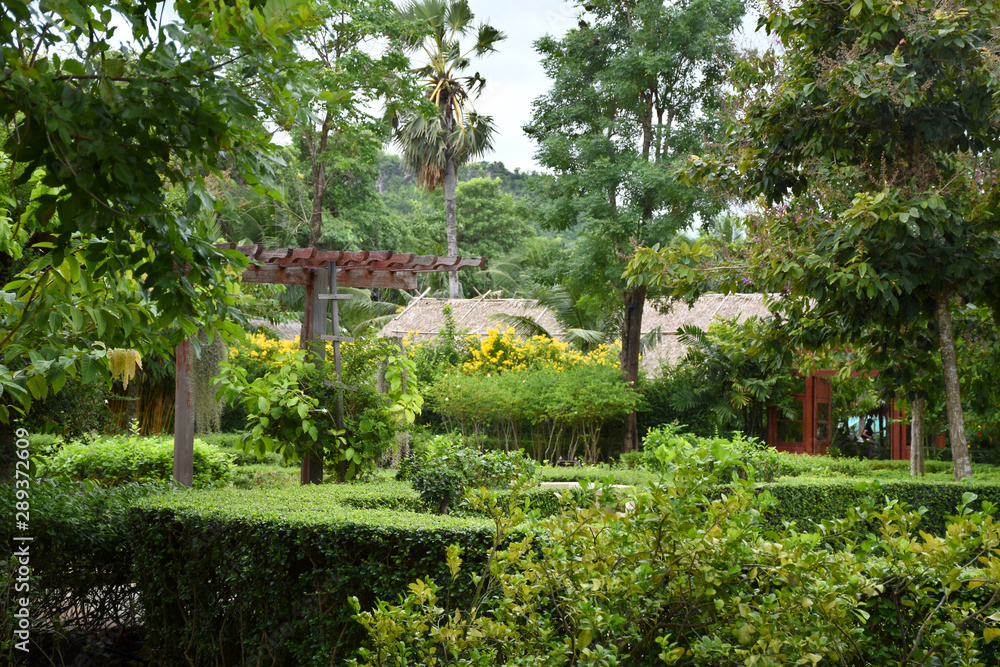 Kanchanaburi, Thailand, 09.09.2019: Beautiful garden, lake, traditional Thai, Siamese clothes, buildings of 