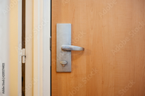 Aluminum steel door handle in modern hotel in Paris © ifeelstock