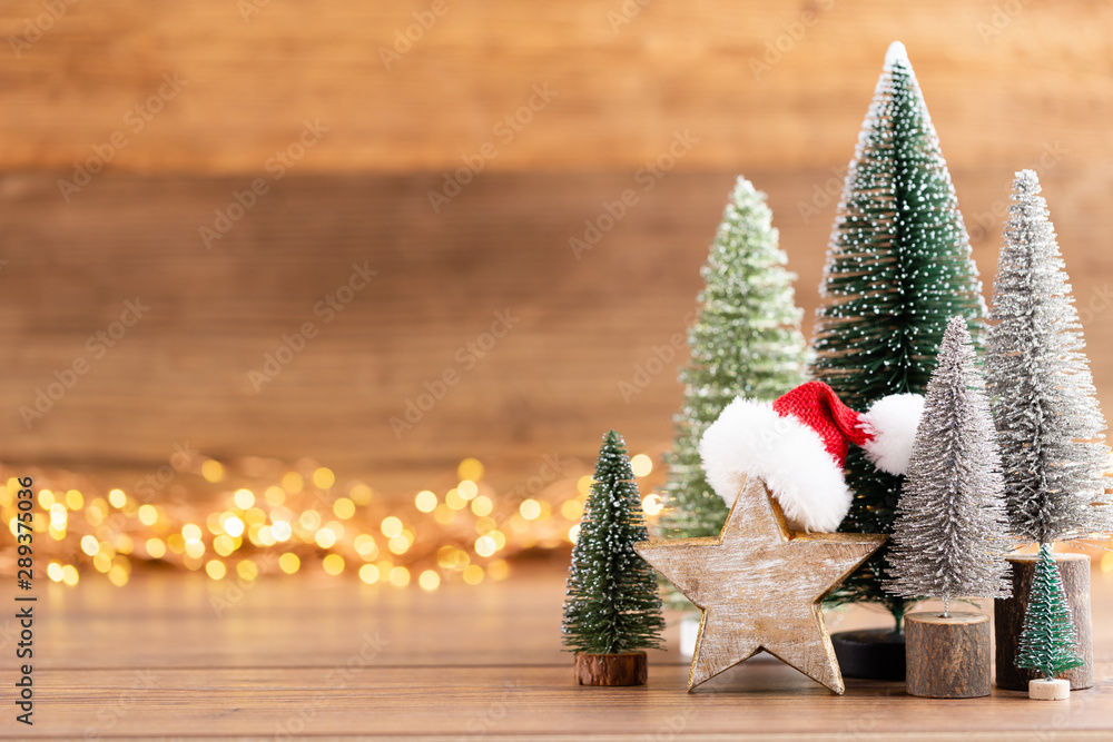 Colorful Christmas tree on wooden, bokeh background. - obrazy, fototapety, plakaty 