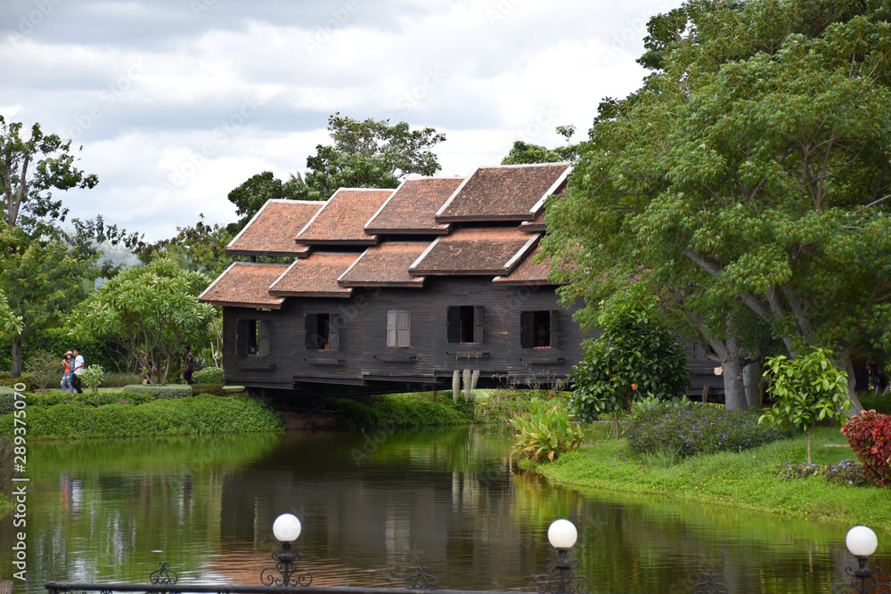 Fototapeta premium Kanchanaburi, Thailand, 09.09.2019: Beautiful garden, lake, traditional Thai, Siamese clothes, buildings of 