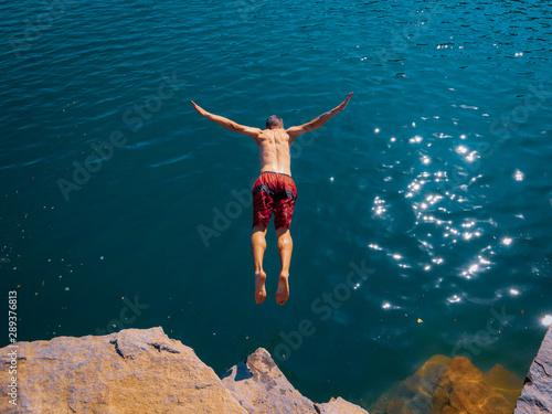 young man jumping on the beach