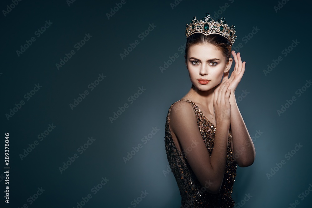 Beautiful woman in golden dress and crown Beautiful woman in golden dress and crown