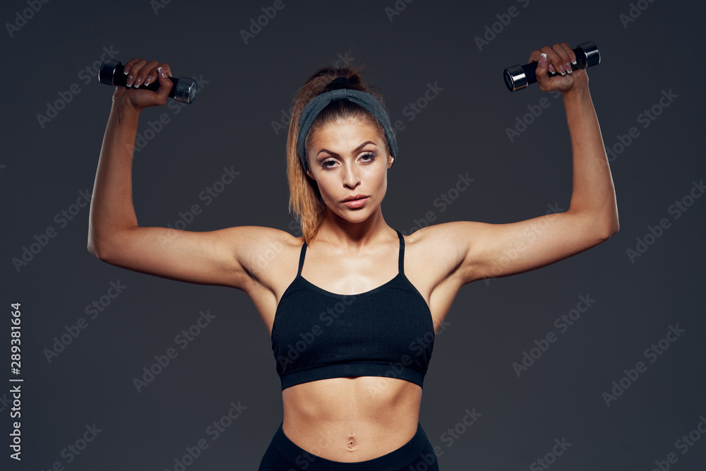 woman exercising with dumbbells woman exercising with dumbbells