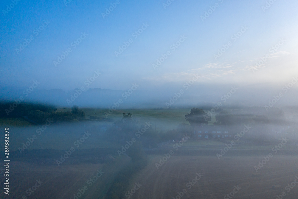 Aerial View over British Countryside in Fog