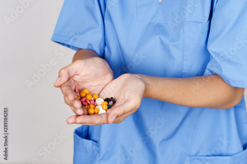 doctor holding pills in his hand