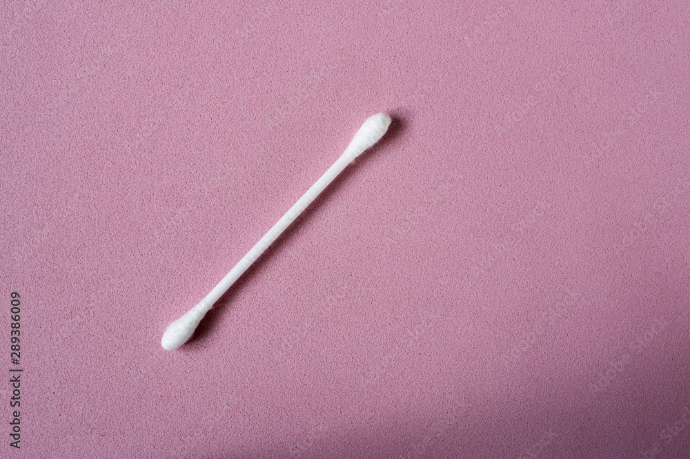 Cotton bud on a pink background. Sanitary qtip hygenic accessory. Cotton bud on a pink background. Sanitary qtip hygenic accessory.