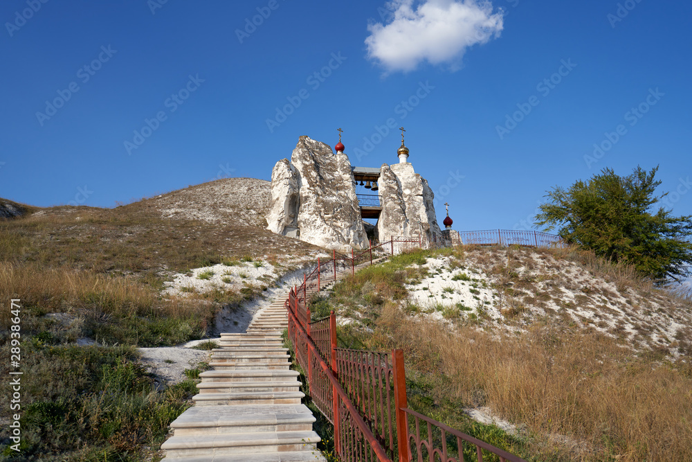 Panorama to the stairway to the Spassky Cave Temple which carved in a chalky rock, Orthodox Kostomarovo St. Saviour Convent, Voronezh Region, Russia.   