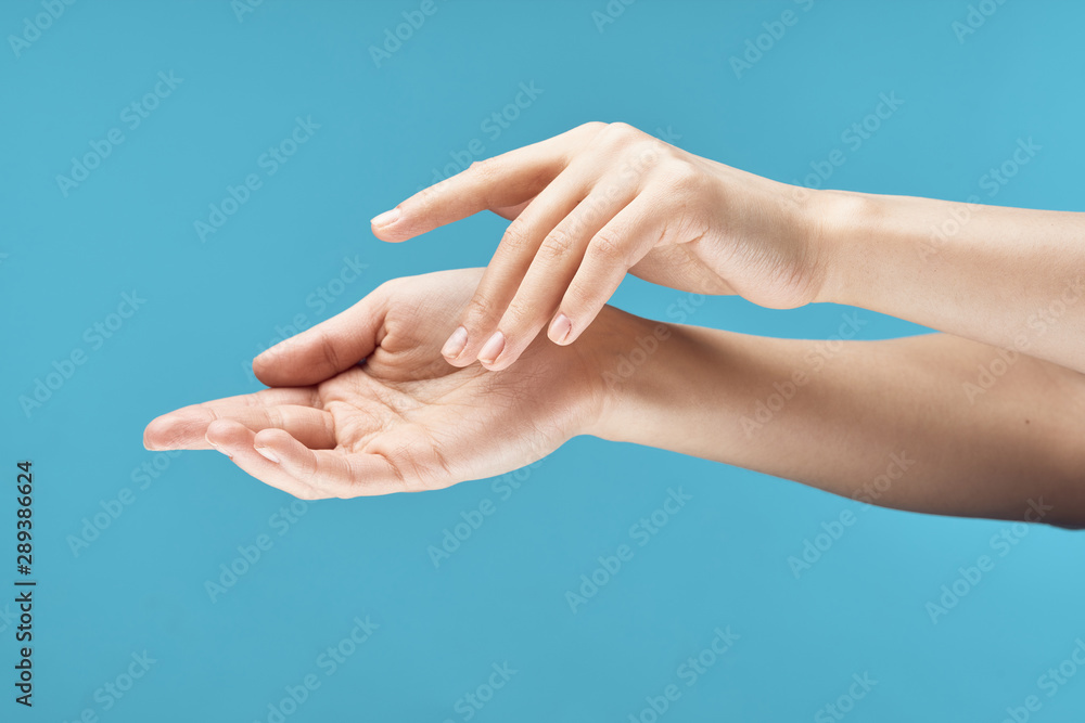 hands of man and woman on blue background