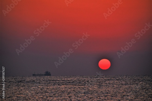a sunrise at sea in red colors