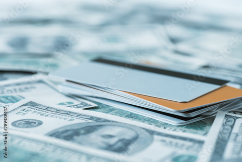 selective focus of dollar banknotes near credit cards
