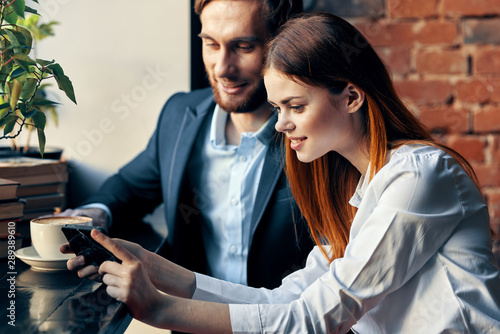 man and woman talking on mobile phone