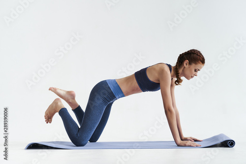 woman doing stretching exercise at yoga
