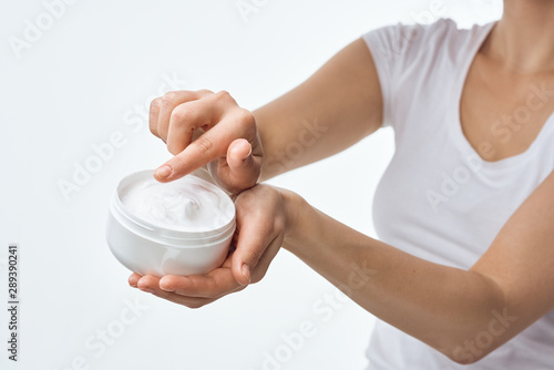 woman applying cream on her face