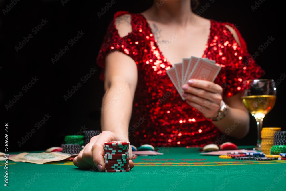 BACKGROUND FOR CASINO. A girl in an evening red dress plays in a casino. Gambling business casino BACKGROUND FOR CASINO. A girl in an evening red dress plays in a casino. Gambling business casino