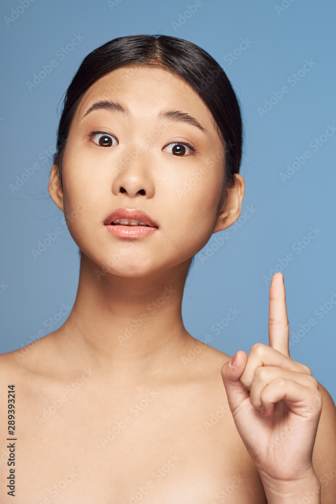 young woman with finger on her lips young woman with finger on her lips