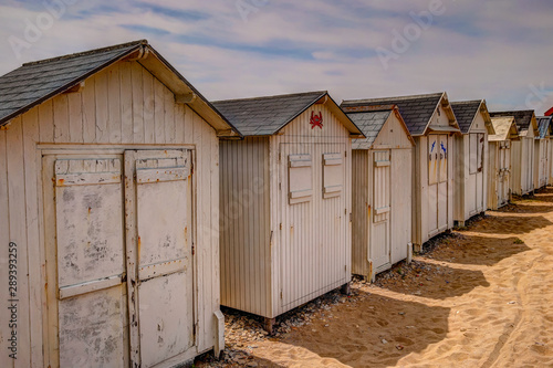 Beach huts along the boardwalk in Normandy France © Torval Mork