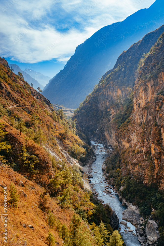 River flows trough rocky valley in Himalaya mountains in Nepal.