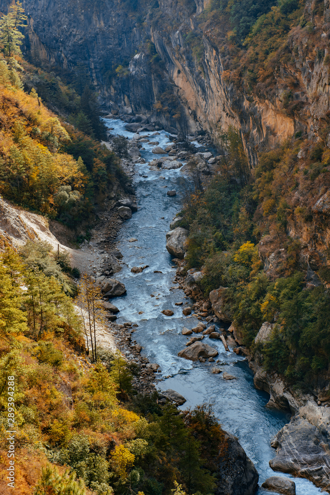 River flows trough rocky valley in Himalaya mountains in Nepal. River flows trough rocky valley in Himalaya mountains in Nepal.