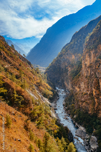 River flows trough rocky valley in Himalaya mountains in Nepal.