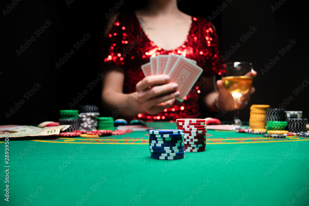 BACKGROUND FOR CASINO. A girl in an evening red dress plays in a casino. Gambling business casino BACKGROUND FOR CASINO. A girl in an evening red dress plays in a casino. Gambling business casino