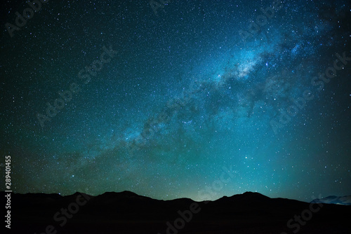The milky way shining in the Siloli desert at high altitude in the Andes mountain range of Bolivia near Atacama, South America.  photo