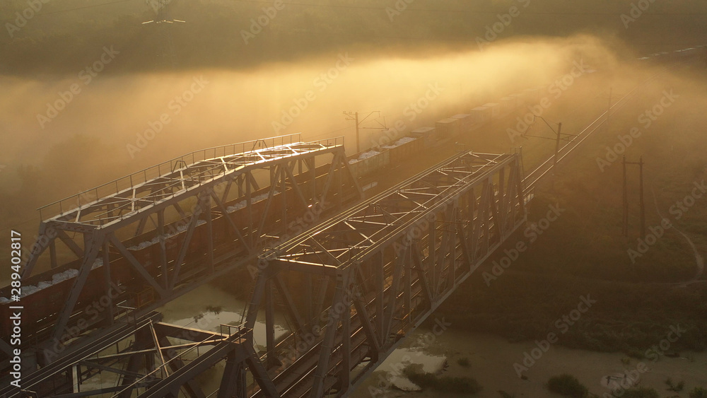 Drone view Double railway bridge over river in morning fog