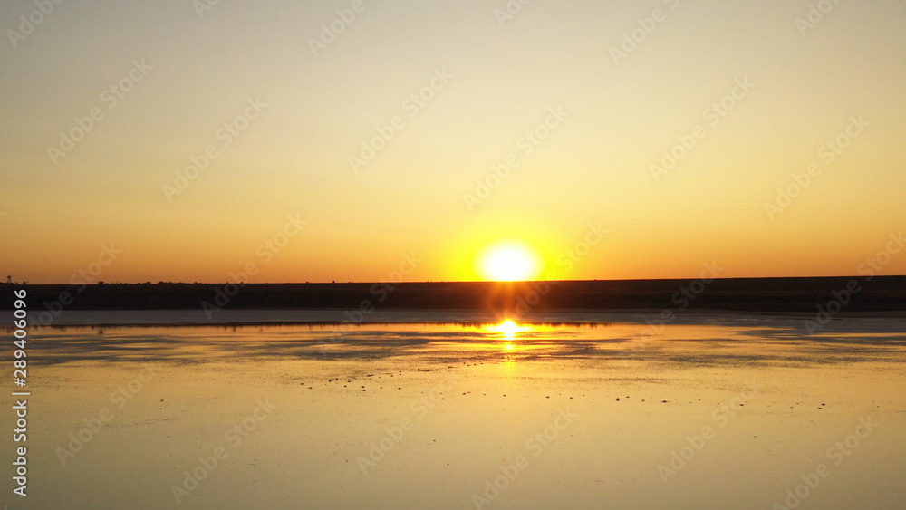 Drone wiev Orange dawn over foggy lake. the sky is well reflected in the water Drone wiev Orange dawn over foggy lake. the sky is well reflected in the water