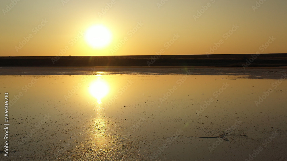 Drone wiev Orange dawn over foggy lake. the sky is well reflected in the water Drone wiev Orange dawn over foggy lake. the sky is well reflected in the water