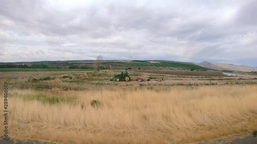 POV of the passenger while riding in a Class A RV that is driving through an agricultural area of the Okanogan Highlands of north central Washington State POV of the passenger while riding in a Class A RV that is driving through an agricultural area of the Okanogan Highlands of north central Washington State