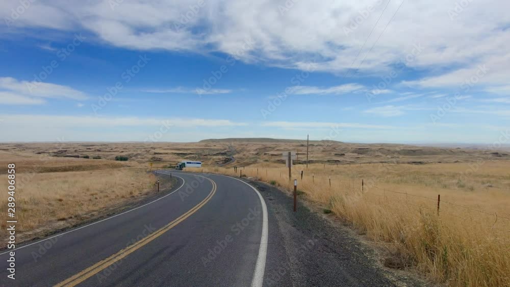 Semi tractor trailer turning onto the highway and driving towards the camera in the Scablands in Eastern Washington State Semi tractor trailer turning onto the highway and driving towards the camera in the Scablands in Eastern Washington State