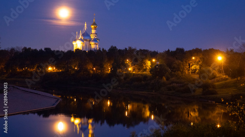 St. Sophia Cathedral and bell tower at night, against a full moon.