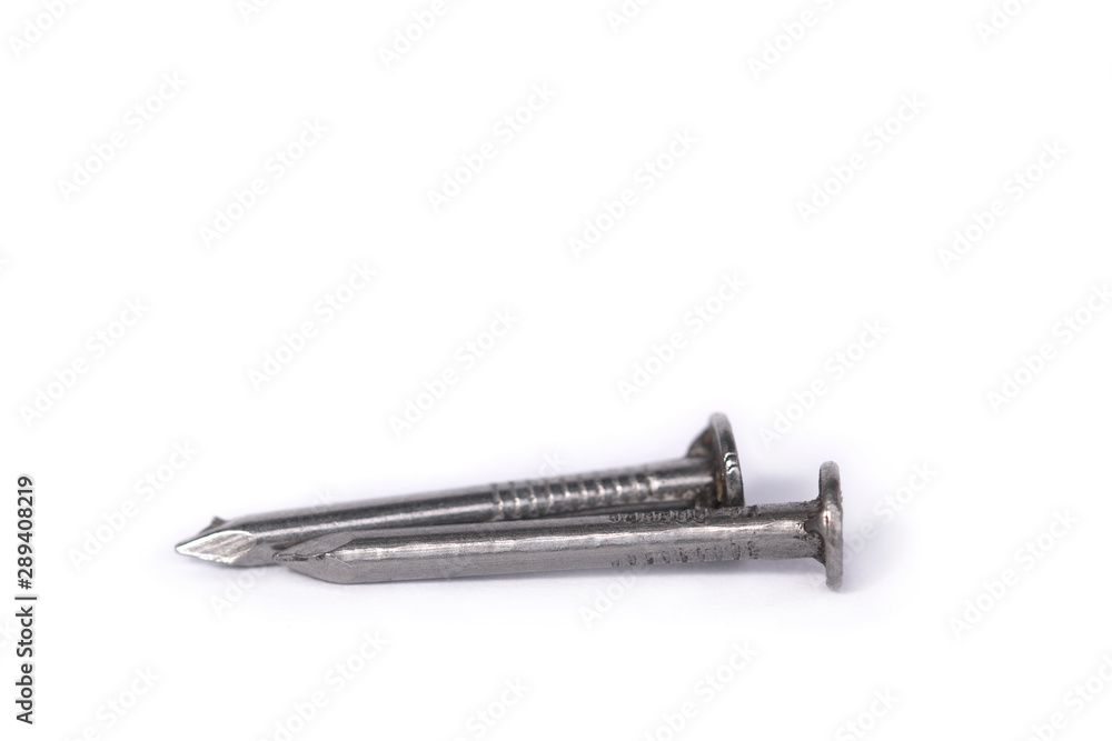Steel nails with sharp ends close-up on a white isolated background. Macro sharp nails.
