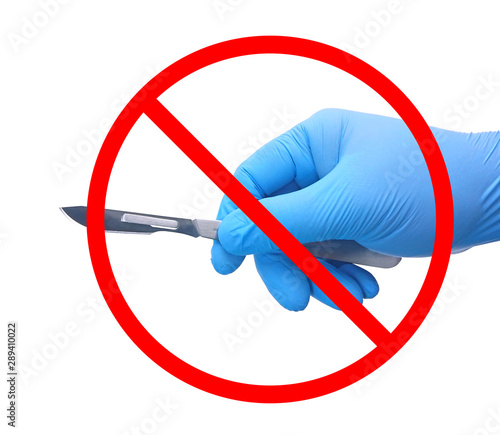 No surgery sign, Hand of surgeon in blue medical glove holding a scalpel with red forbidden isolated on white background