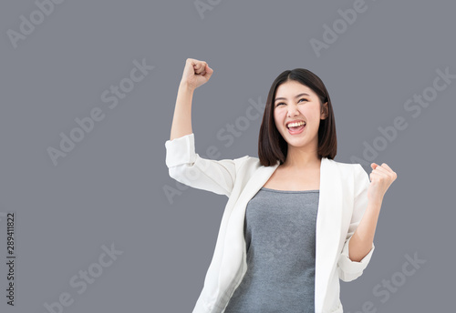 Young professional Asian woman raising her arms up feeling cheerful triumphant happiness and successful celebrating business or successful job, the concept of successful emotional, Clipping path embed