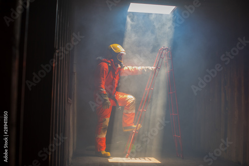 A Firefighter are preparing stairs to help people in the building, in the case of fire.