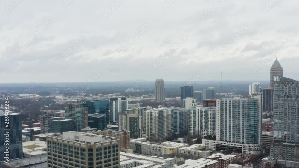 Drone shot above Midtown Atlanta on a cloudy day after a storm. Panning from west to north facing into Midtown Drone shot above Midtown Atlanta on a cloudy day after a storm. Panning from west to north facing into Midtown