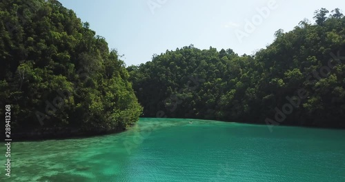 Paddling in luxury island in the philippines club tara surrounded by crystal blue water  4k droneshot photo