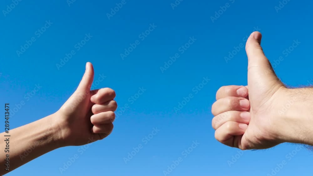 Simbol of approval like positive emotion. A man and a woman show their hands using a gesture-class, thumbs up. Close up. Simbol of approval like positive emotion. A man and a woman show their hands using a gesture-class, thumbs up. Close up.