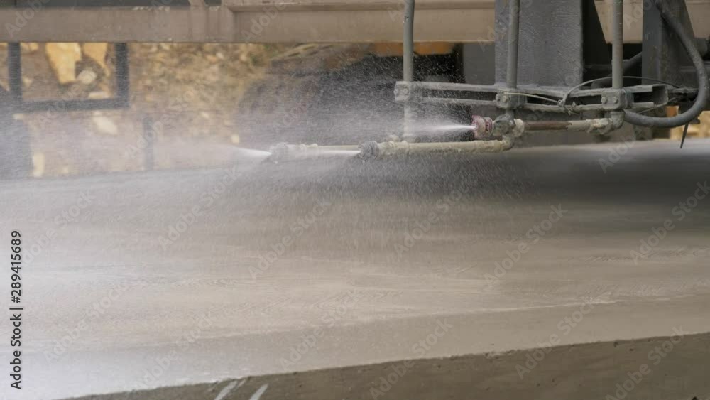 Fully mechanised construction of concrete road. Spraying speciality