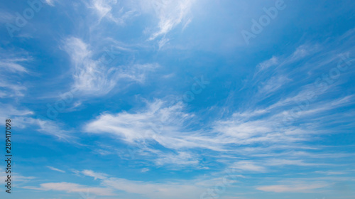 Photography Wispy cirrus clouds on bright blue sky background in summer