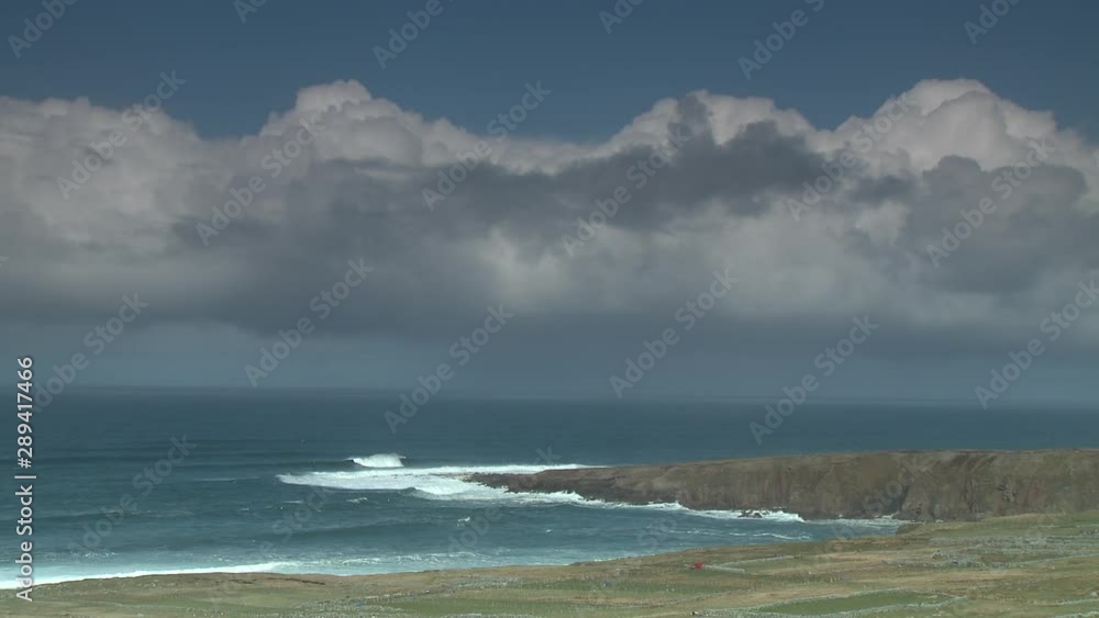 Steady, extreme wide shot of waves crashing onto a peninsula. Steady, extreme wide shot of waves crashing onto a peninsula.