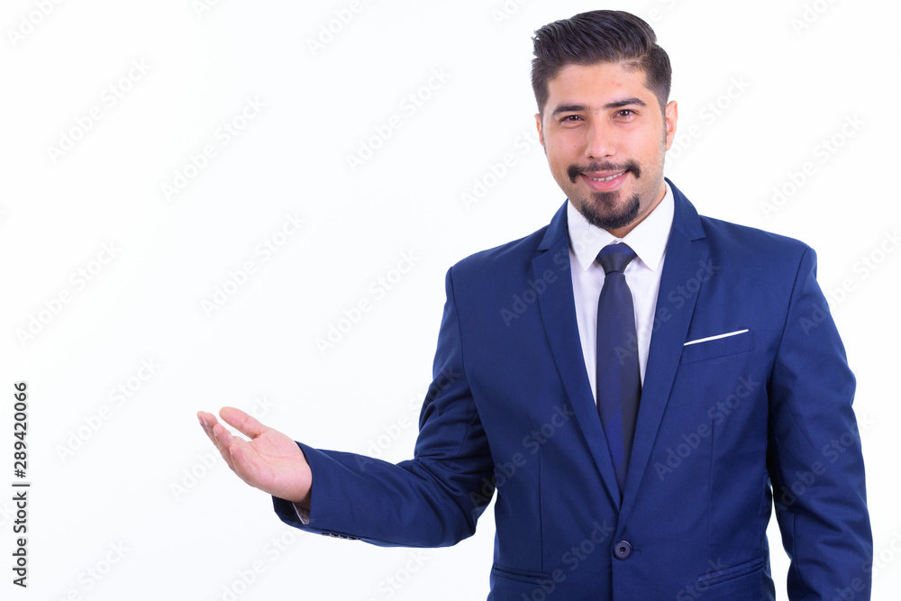 Happy bearded Persian businessman in suit showing something Happy bearded Persian businessman in suit showing something