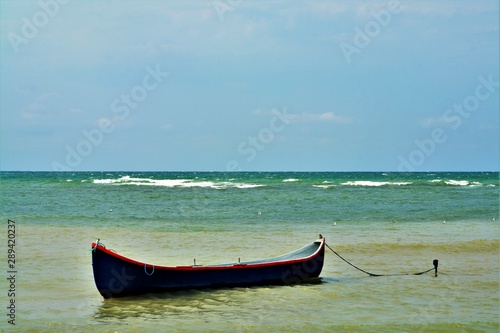 a boat anchored at the seashore