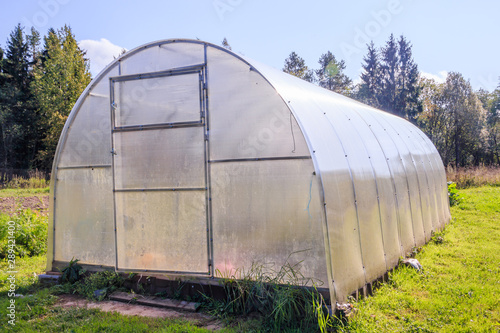 Greenhouse. Bright greenhouse in the garden. Indoor stationary greenhouse © alenka2194
