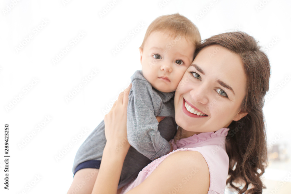 Loving mother with her baby on light background Loving mother with her baby on light background