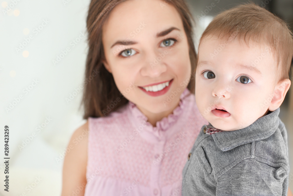 Loving mother with her baby on light background Loving mother with her baby on light background