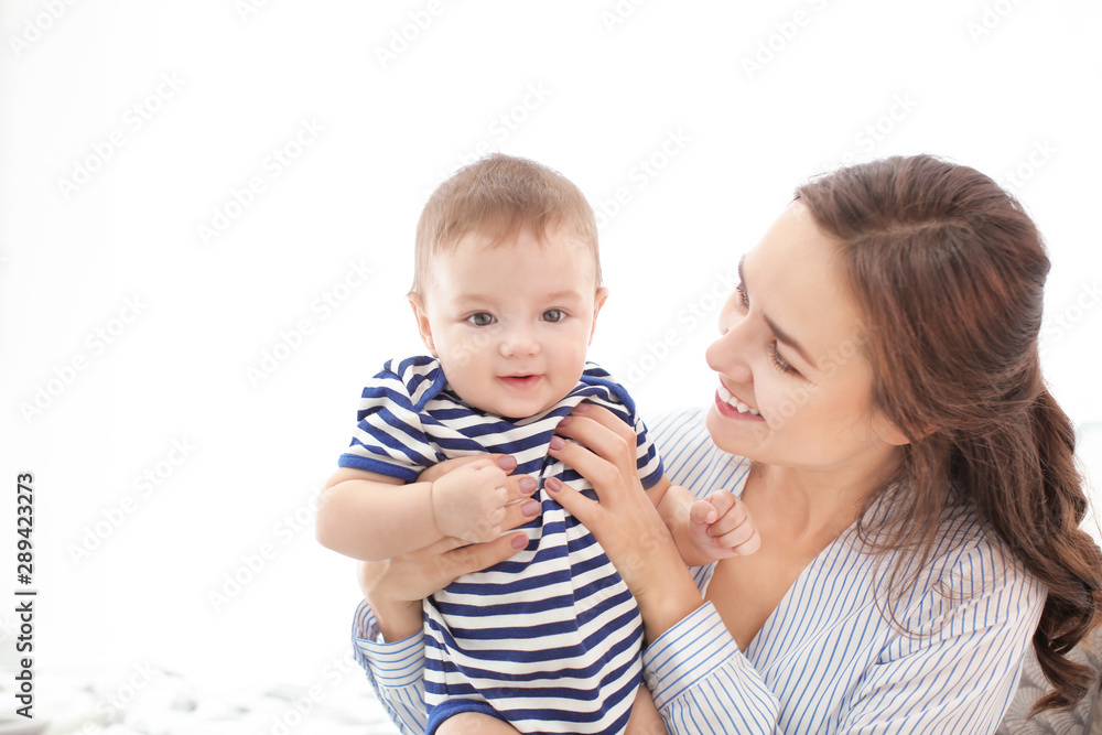 Loving mother with her baby on light background Loving mother with her baby on light background