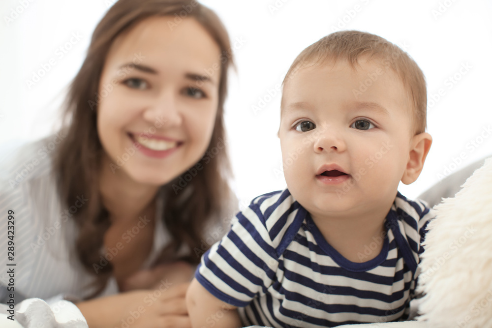 Loving mother with her baby on light background Loving mother with her baby on light background