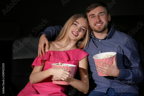 Young couple watching movie...